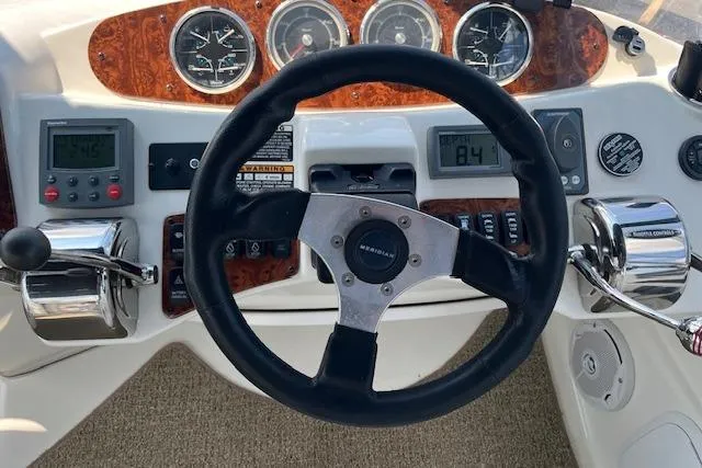 Slide: The Image of 2005 Meridian 368 Motoryacht dashboard with steering wheel and control gauges. - 14