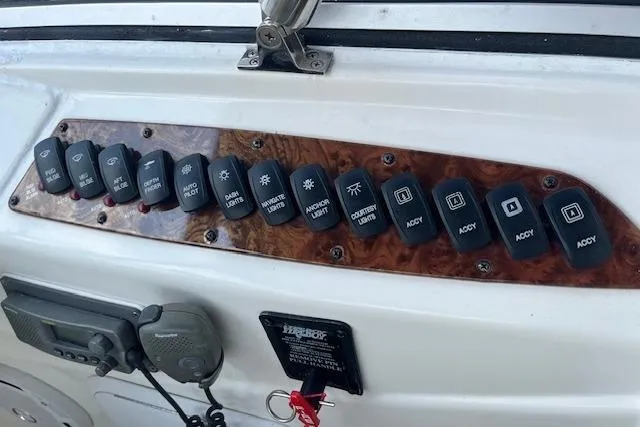 Slide: The Image of Control panel of a 2005 Meridian 368 Motoryacht with labeled switches and radio equipment. - 19