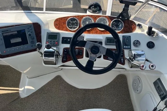 Slide: The Image of Helm of 2005 Meridian 368 Motoryacht with steering wheel and navigation controls. - 22