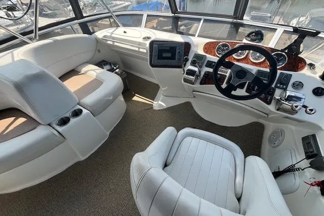 Slide: The Image of 2005 Meridian 368 Motoryacht cockpit with plush seating and modern navigation controls. - 23