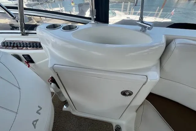 Slide: The Image of 2005 Meridian 368 Motoryacht interior with sink and cup holders, docked at marina. - 24