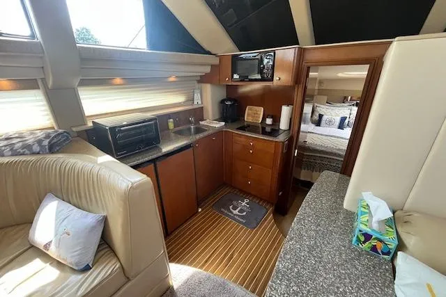 Slide: The Image of Interior of 2005 Meridian 368 Motoryacht with kitchen and cozy seating area. - 34