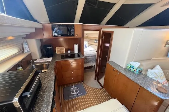 Slide: The Image of Interior of 2005 Meridian 368 Motoryacht with modern kitchen and cozy bedroom. - 35