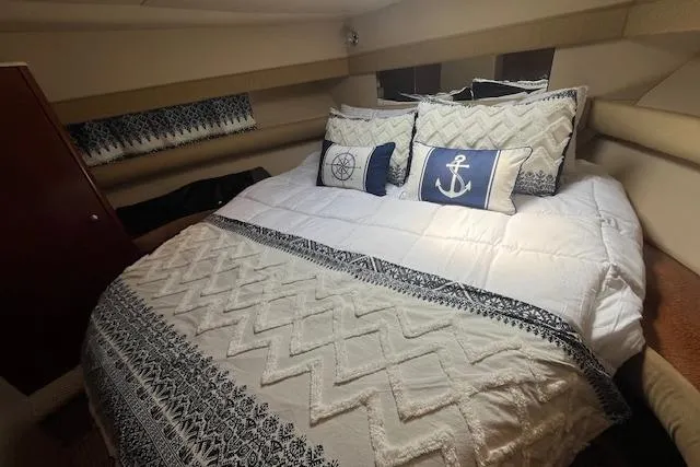 Slide: The Image of Cozy bedroom in 2005 Meridian 368 Motoryacht with nautical-themed bedding. - 38