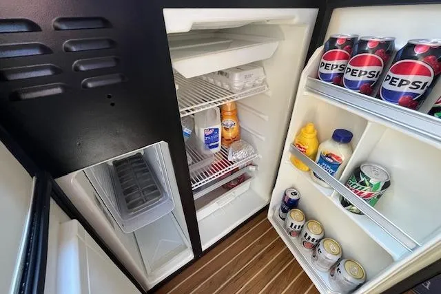 Slide: The Image of Refrigerator stocked with drinks and condiments on a 2005 Meridian 368 Motoryacht. - 45
