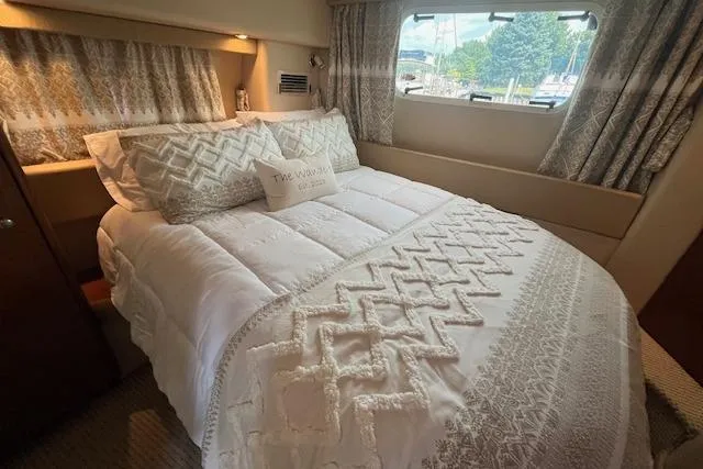 Slide: The Image of Luxurious bedroom interior of 2005 Meridian 368 Motoryacht with elegant bedding and window view. - 58