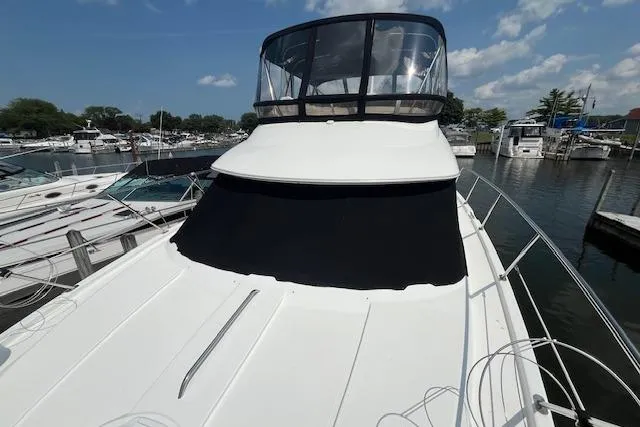 Slide: The Image of 2005 Meridian 368 Motoryacht docked at a marina under a clear blue sky. - 6