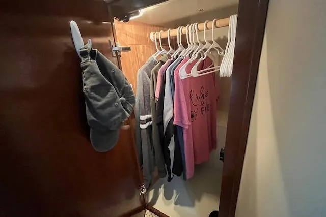 Slide: The Image of Closet in 2005 Meridian 368 Motoryacht with hanging clothes and hats. - 66