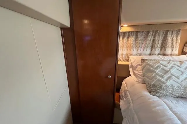 Slide: The Image of Interior of 2005 Meridian 368 Motoryacht bedroom with wooden cabinet and bed. - 67