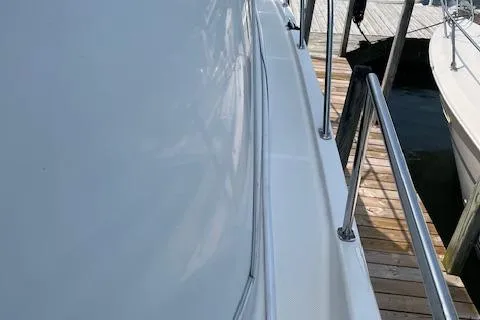 Slide: The Image of 2005 Meridian 368 Motoryacht docked, showing sleek side view and railing. - 8