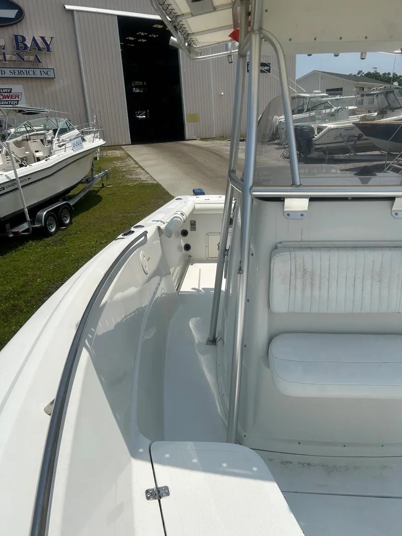 Slide: The Image of 2004 Sailfish 236 CC boat interior, featuring seating and open deck area. - 14