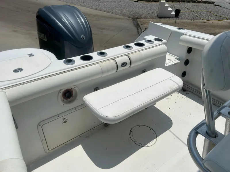 Slide: The Image of 2004 Sailfish 236 CC boat interior with seating and rod holders. - 20