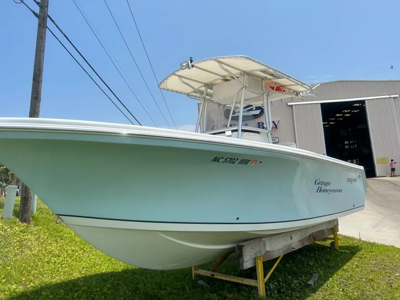Slide: The Image of 2004 Sailfish 236 CC boat on display outside a large warehouse. - 8
