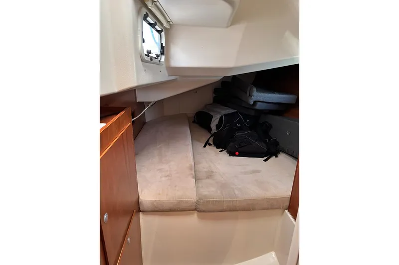 Slide: The Image of 2014 Hanse 445 yacht cabin interior with bed and storage space. - 16