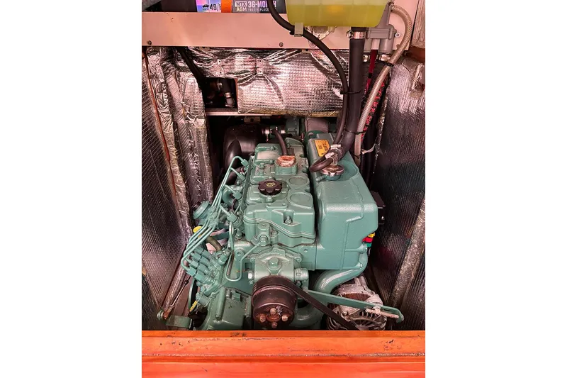 Slide: The Image of Engine compartment of a 2014 Hanse 445 sailboat, featuring a green marine engine. - 22