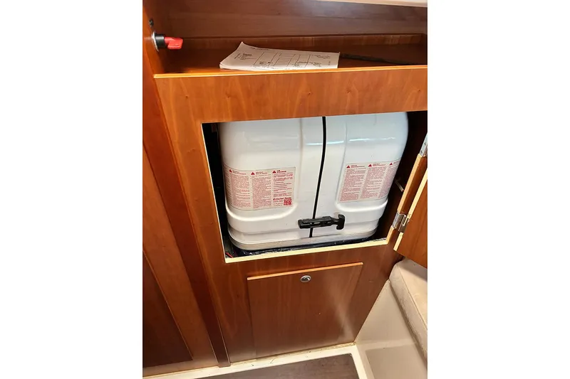 Slide: The Image of 2014 Hanse 445 interior storage with white tank and wooden cabinetry. - 23