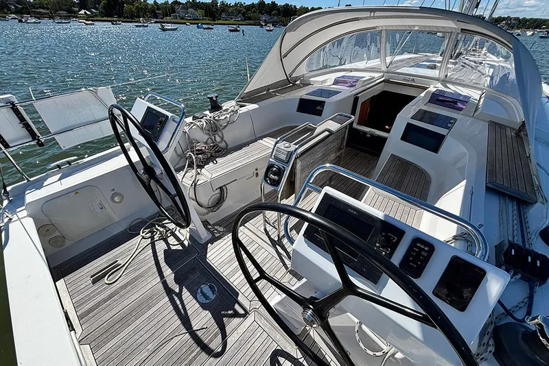 Slide: The Image of 2014 Hanse 445 sailboat cockpit with dual steering wheels and navigation equipment. - 6