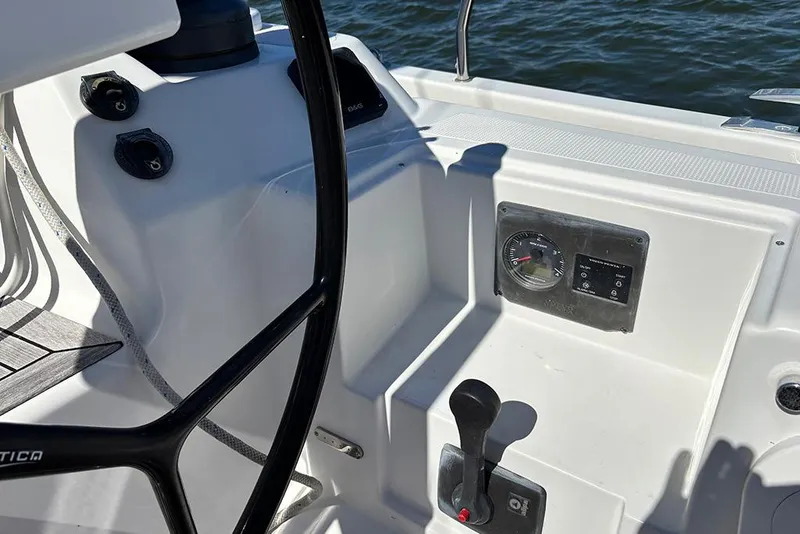 Slide: The Image of Cockpit controls of a 2014 Hanse 445 sailboat, featuring steering wheel and instrument panel. - 8