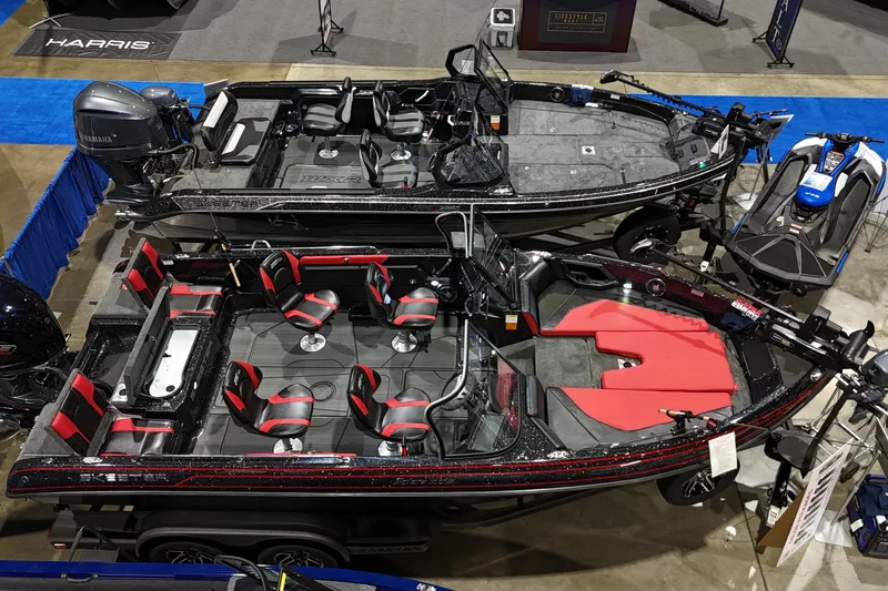 Slide: The Image of 2025 Skeeter Solera 205 boats on display at a showroom, featuring sleek design and seating. - 2