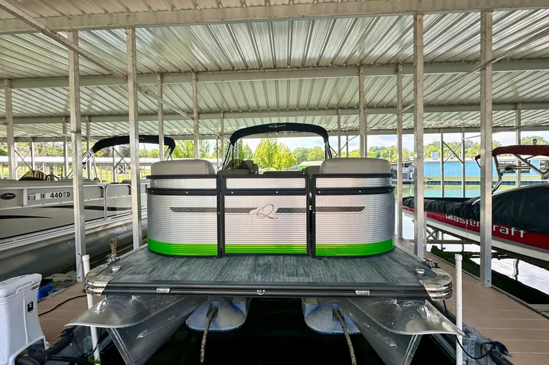 Slide: The Image of 2023 Qwest LT 820 pontoon boat docked in a covered marina. - 0