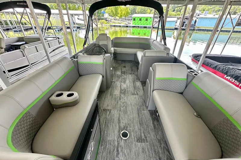 Slide: The Image of 2023 Qwest LT 820 pontoon boat interior with gray seating and green accents. - 10