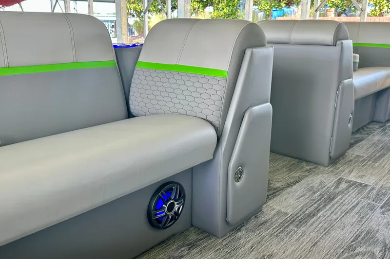 Slide: The Image of 2023 Qwest LT 820 interior with gray seating, green accents, and speaker system. - 15