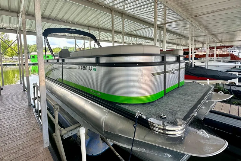 Slide: The Image of 2023 Qwest LT 820 pontoon boat docked under a covered marina. - 3