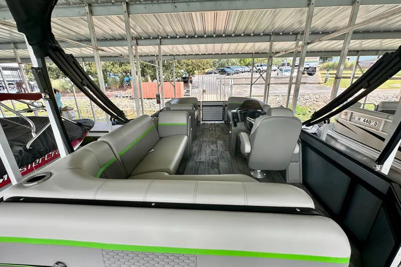 Slide: The Image of 2023 Qwest LT 820 pontoon boat interior with modern seating and steering console. - 9