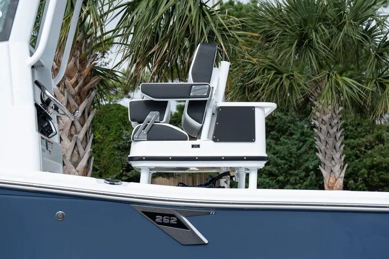 Slide: The Image of 2026 Blackfin 262 HB boat with sleek seating, set against a backdrop of palm trees. - 10