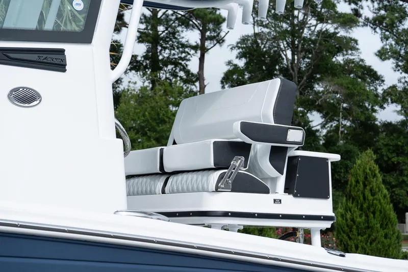 Slide: The Image of 2026 Blackfin 262 HB boat seating with sleek design and lush greenery background. - 11