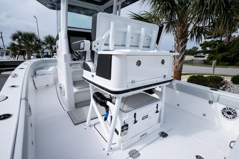 Slide: The Image of 2026 Blackfin 262 HB boat interior with fishing rod holders and Yeti cooler. - 18
