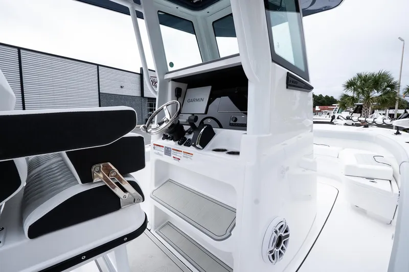 Slide: The Image of 2026 Blackfin 262 HB boat interior with steering wheel and seating. - 29