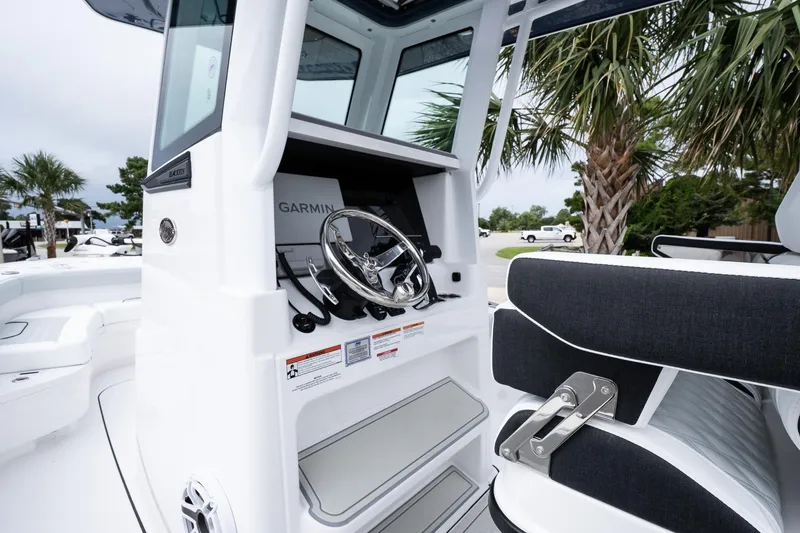 Slide: The Image of 2026 Blackfin 262 HB boat helm with Garmin navigation, sleek design, and comfortable seating. - 30