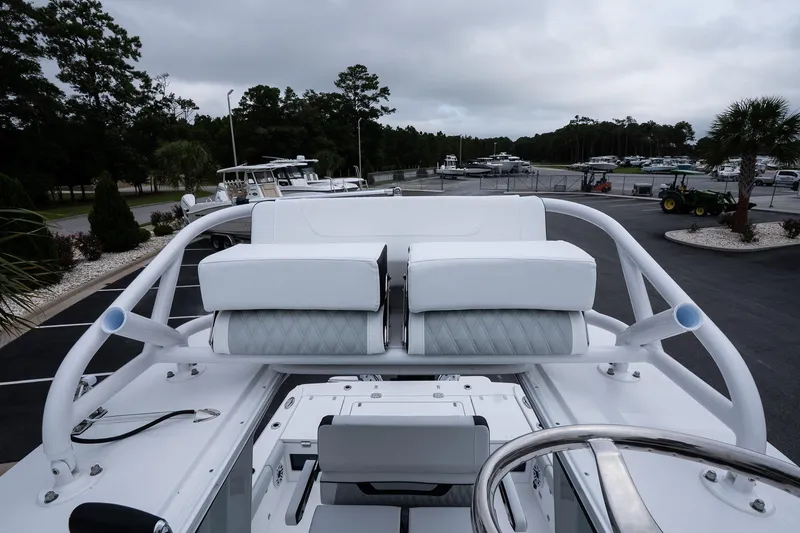 Slide: The Image of 2026 Blackfin 262 HB boat with sleek white seating and modern design in a marina setting. - 37