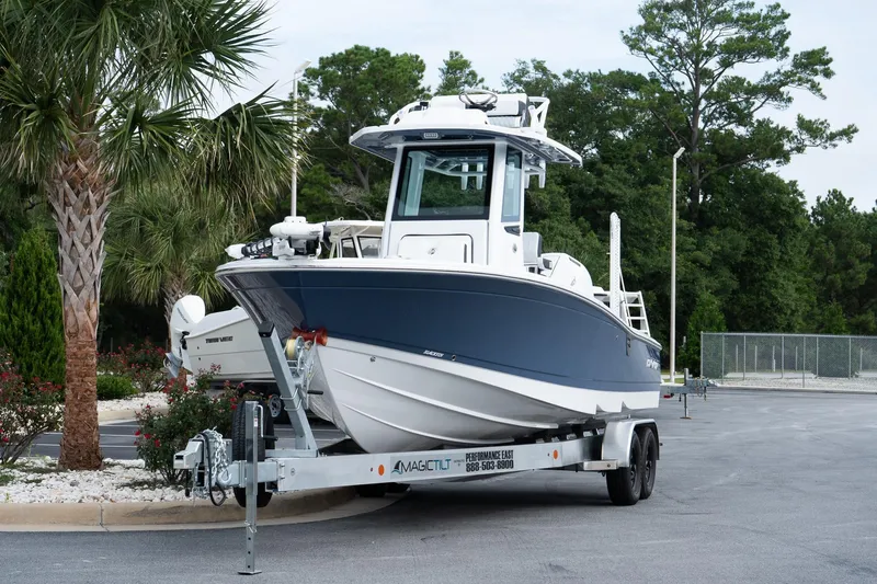 Slide: The Image of 2026 Blackfin 262 HB boat on trailer, parked near palm trees. - 4
