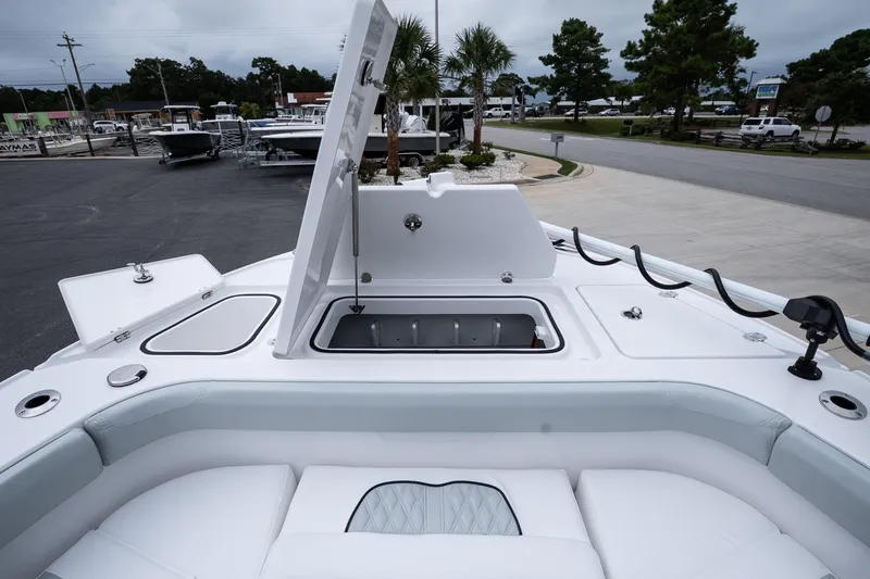 Slide: The Image of 2026 Blackfin 262 HB boat with open storage compartment, docked in a marina. - 42