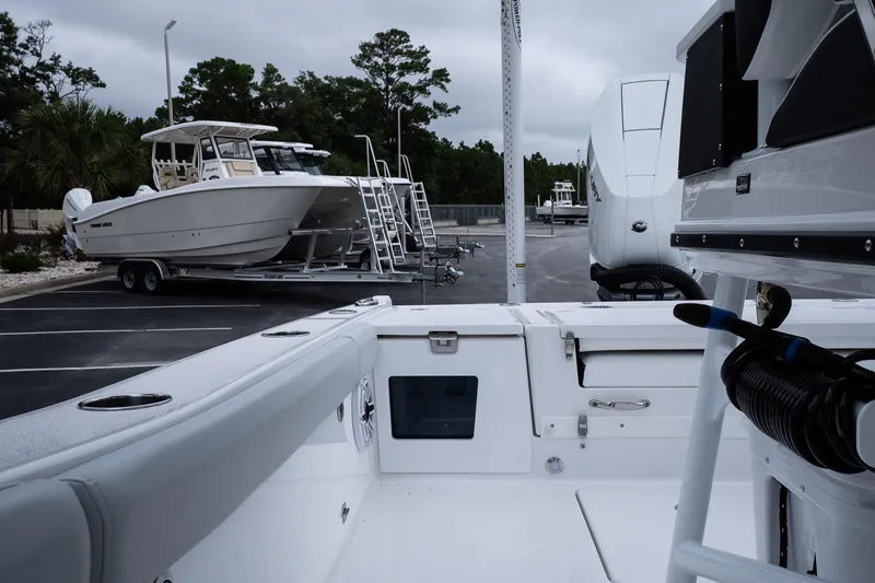 Slide: The Image of 2026 Blackfin 262 HB boat in parking lot, surrounded by trees and trailers. - 48