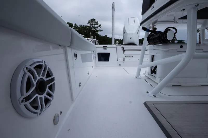 Slide: The Image of 2026 Blackfin 262 HB boat interior with speaker and seating area. - 49