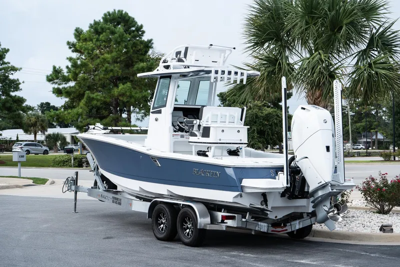 Slide: The Image of 2026 Blackfin 262 HB boat on trailer, parked near palm trees. - 6