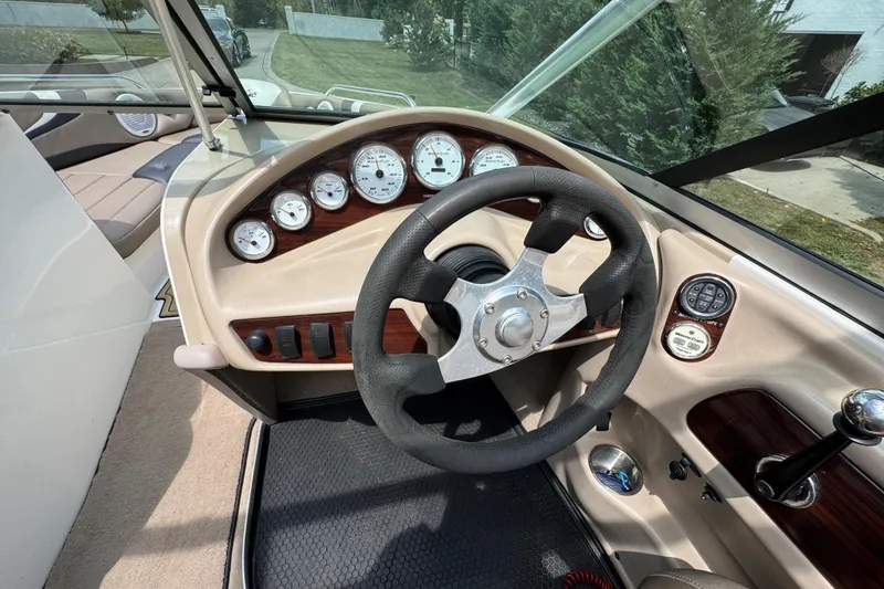Slide: The Image of 2002 MasterCraft ProStar 209 boat dashboard with steering wheel and gauges. - 14