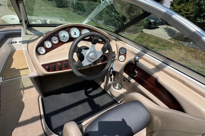 Slide: The Image of 2002 MasterCraft ProStar 209 boat interior with steering wheel and dashboard controls. - 15