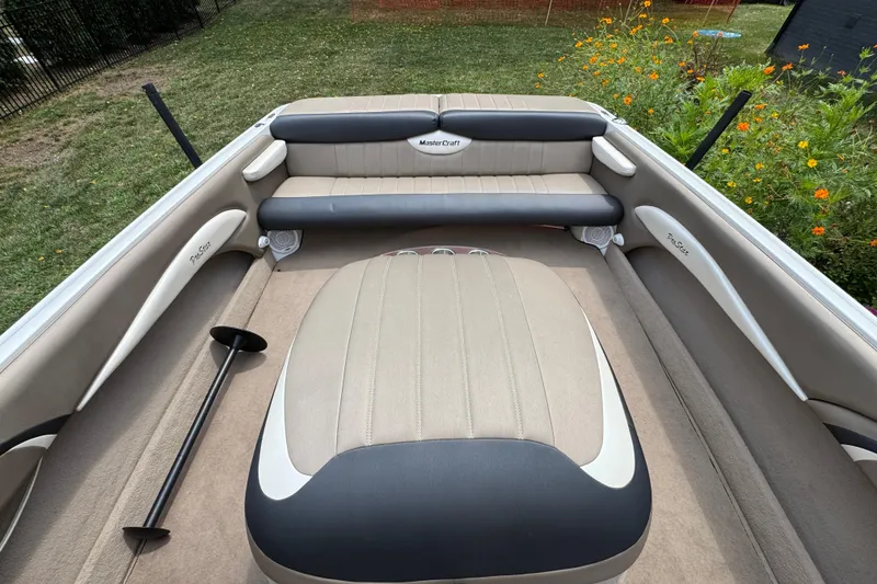 Slide: The Image of 2002 MasterCraft ProStar 209 boat interior with beige and black seating. - 9