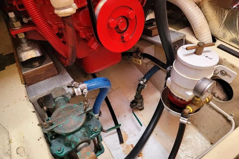 Slide: The Image of Engine compartment of 1987 Pearson 39-2 with 2016 Beta engine, featuring hoses and components. - 11