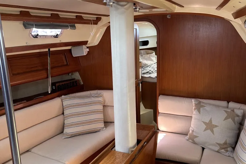 Slide: The Image of Cozy interior of 1987 Pearson 39-2 sailboat with comfortable seating and wooden accents. - 12