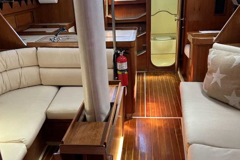Slide: The Image of Interior of 1987 Pearson 39-2 sailboat with 2016 Beta engine, featuring cozy seating and wood finish. - 17