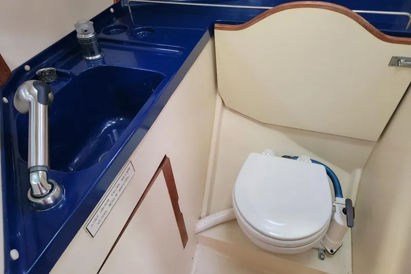 Slide: The Image of Compact marine bathroom with blue sink and toilet in 1987 Pearson 39-2 yacht. - 18