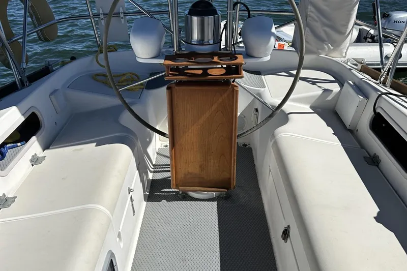 Slide: The Image of Cockpit of 1987 Pearson 39-2 sailboat with 2016 Beta engine, featuring steering wheel and seating. - 2