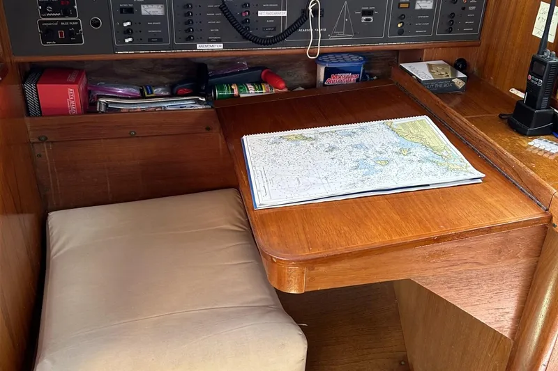 Slide: The Image of Navigation station in 1987 Pearson 39-2 sailboat with map and control panel. - 6