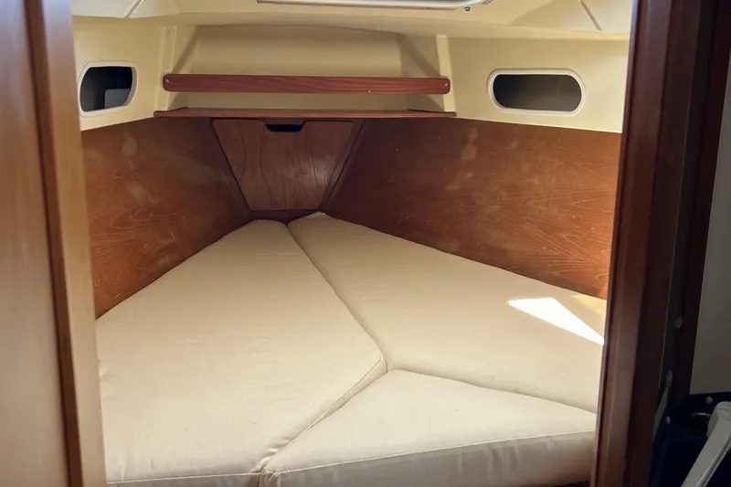 Slide: The Image of Interior cabin of 1987 Pearson 39-2 sailboat with beige cushions and wooden accents. - 13