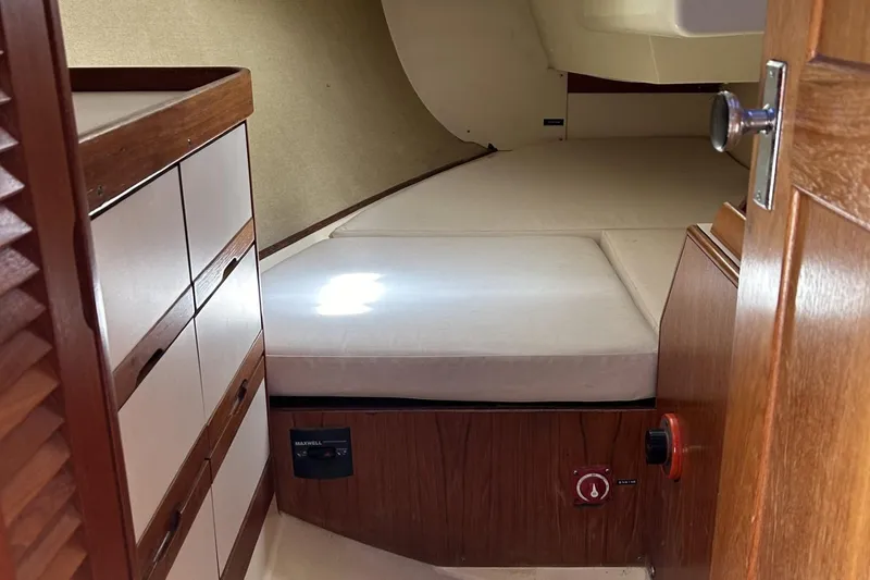 Slide: The Image of Interior cabin of 1987 Pearson 39-2 sailboat with wooden cabinetry and cushioned berth. - 15